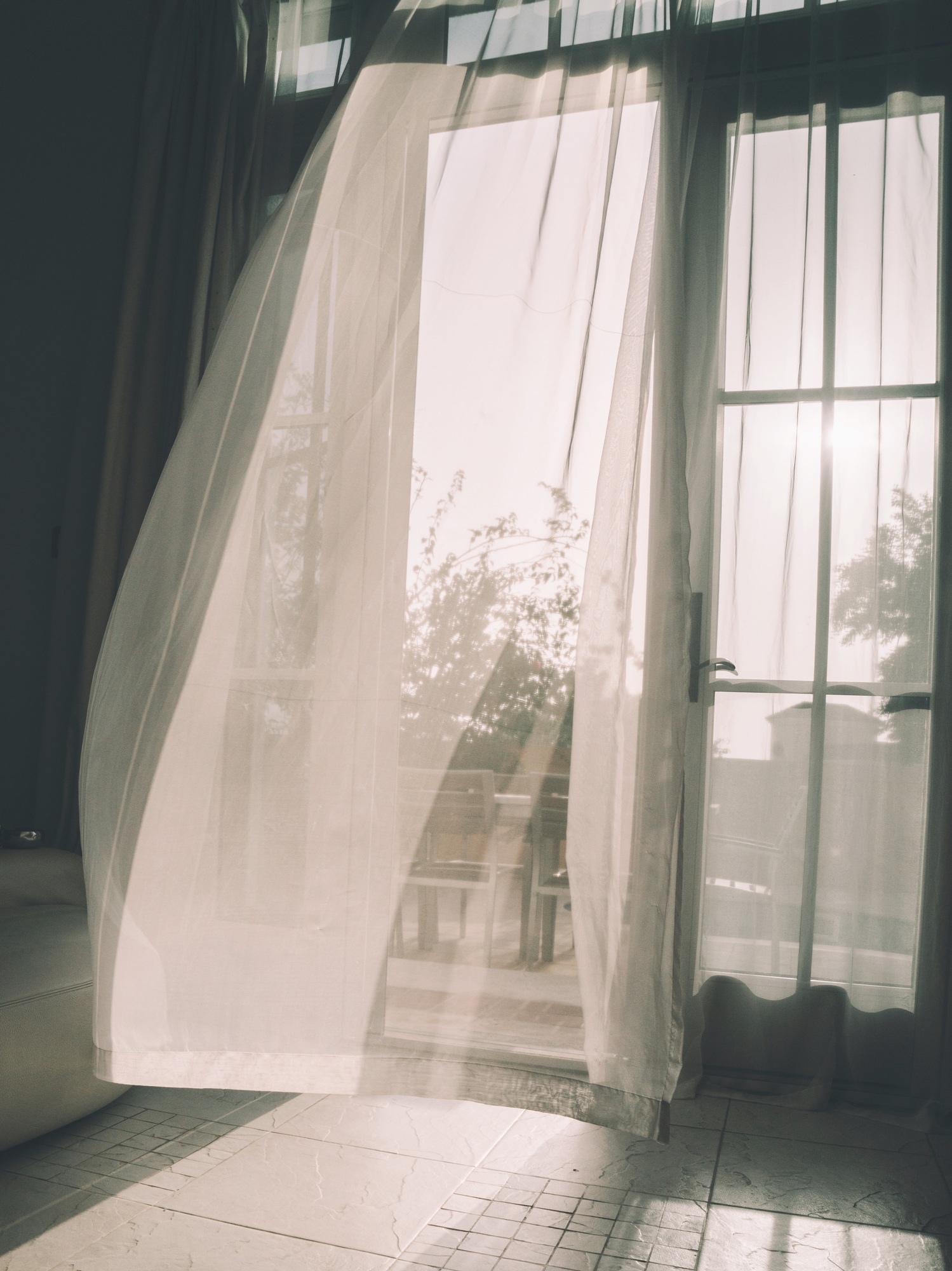 Airy Curtain blowing on the wind in the doorframe